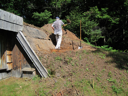 shoveling dirt off entry hill