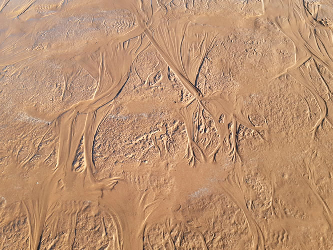 snow melt patterns in sand at Thompson beach